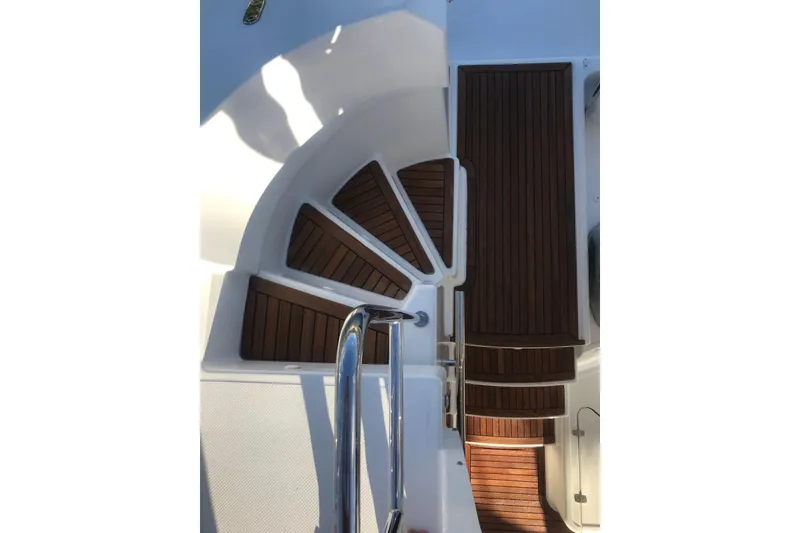 Slide: The Image of Staircase on 2014 FONTAINE PAJOT 63 yacht with wooden steps and metal railing. - 11