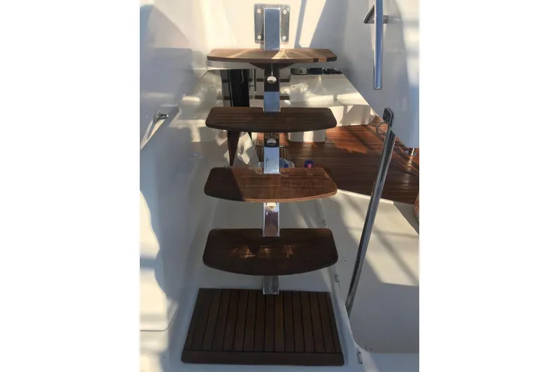 Slide: The Image of Wooden steps on a 2014 FONTAINE PAJOT 63 yacht, leading to the deck. - 13