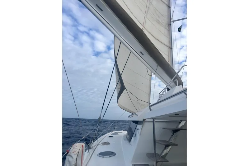 Slide: The Image of Sailing on a 2014 FONTAINE PAJOT 63 catamaran under a partly cloudy sky. - 15