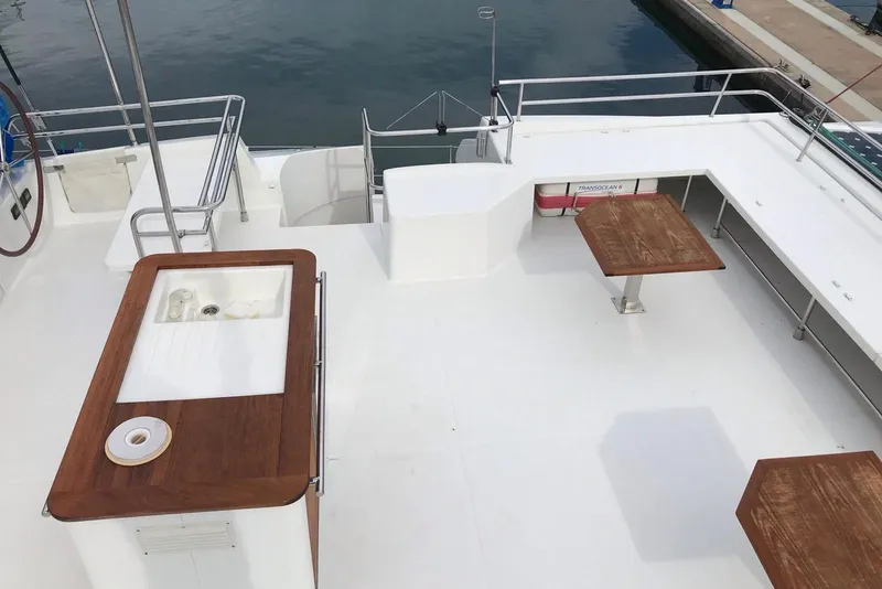 Slide: The Image of Spacious deck of 2014 FONTAINE PAJOT 63 yacht with wooden tables and sink. - 17
