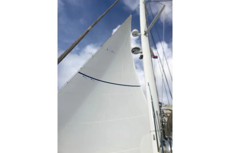 Slide: The Image of Sail of 2014 FONTAINE PAJOT 63 catamaran against a blue sky. - 21
