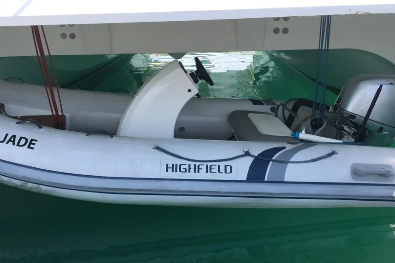 Slide: The Image of Inflatable boat under a 2014 FONTAINE PAJOT 63 catamaran, featuring a Highfield motor. - 25