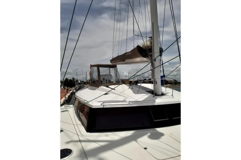Slide: The Image of 2014 FONTAINE PAJOT 63 yacht deck with mast and rigging under cloudy sky. - 31
