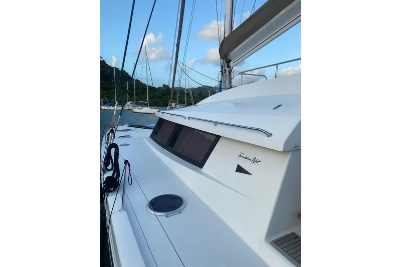 Slide: The Image of 2014 FONTAINE PAJOT 63 yacht docked, showcasing sleek design and modern features. - 33