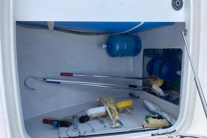 Slide: The Image of Storage compartment on a 2014 FONTAINE PAJOT 63 with cleaning tools and water bottles. - 46