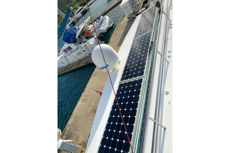 Slide: The Image of 2014 FONTAINE PAJOT 63 yacht with solar panels docked at marina. - 55