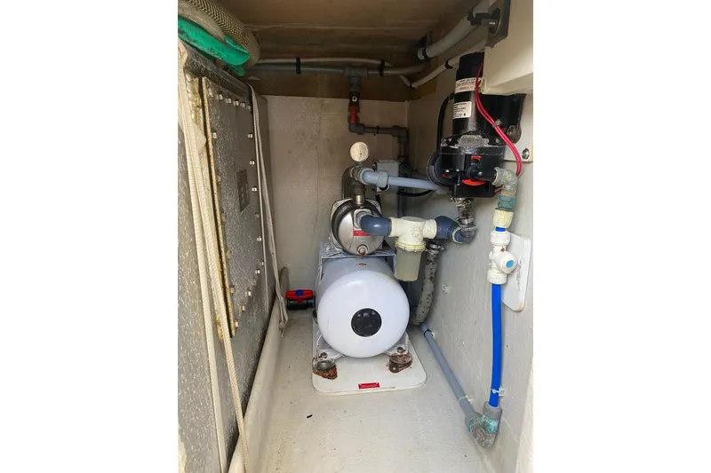 Slide: The Image of Engine room of 2014 FONTAINE PAJOT 63 yacht, featuring mechanical components and piping. - 67