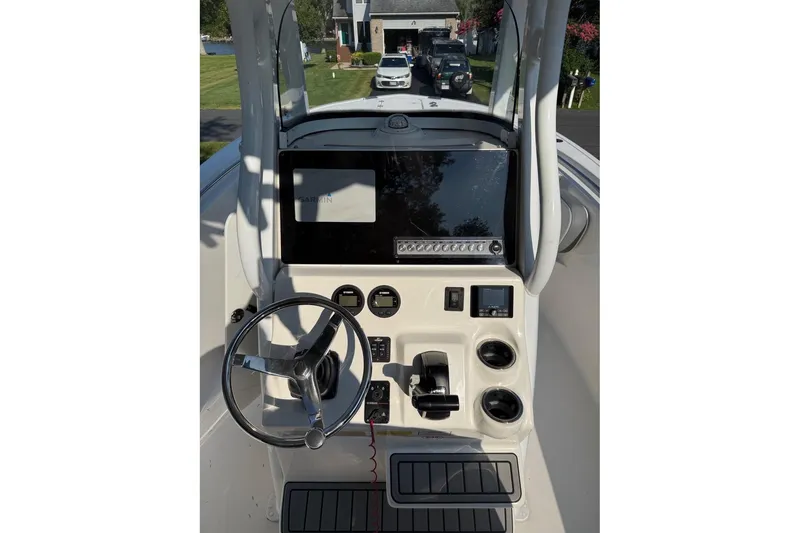 Slide: The Image of 2019 Tidewater 232 CC Adventure boat console with steering wheel and navigation display. - 10