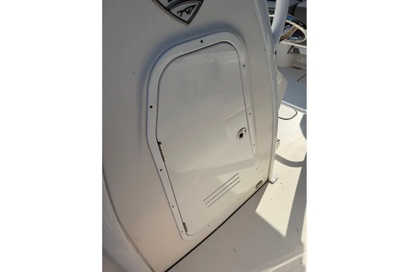 Slide: The Image of 2019 Tidewater 232 CC Adventure boat console door in sunlight. - 11