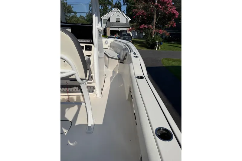 Slide: The Image of 2019 Tidewater 232 CC Adventure boat interior with seating and cup holders. - 13