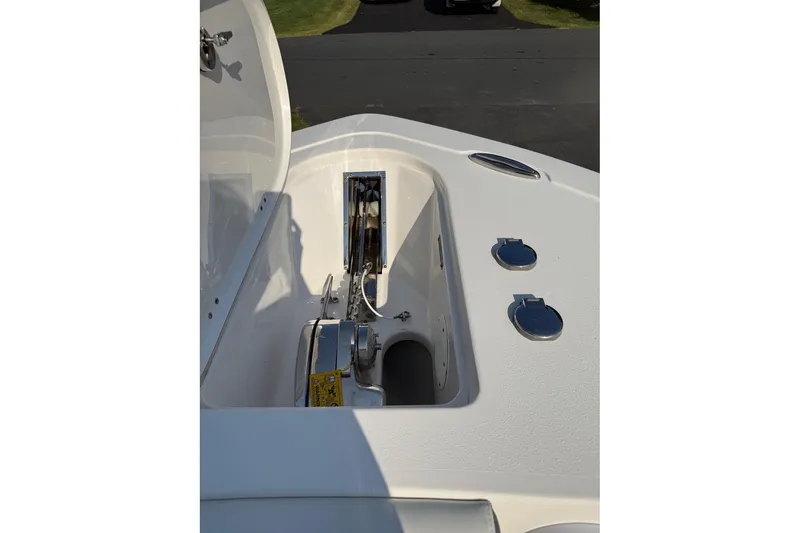 Slide: The Image of 2019 Tidewater 232 CC Adventure boat anchor compartment with open hatch and fittings. - 18