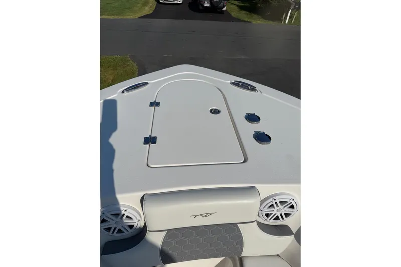 Slide: The Image of 2019 Tidewater 232 CC Adventure boat deck with storage hatch and speakers. - 20