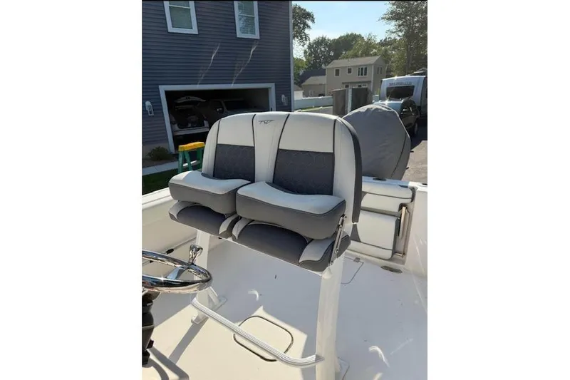 Slide: The Image of 2019 Tidewater 232 CC Adventure boat interior with covered engine and seating. - 3