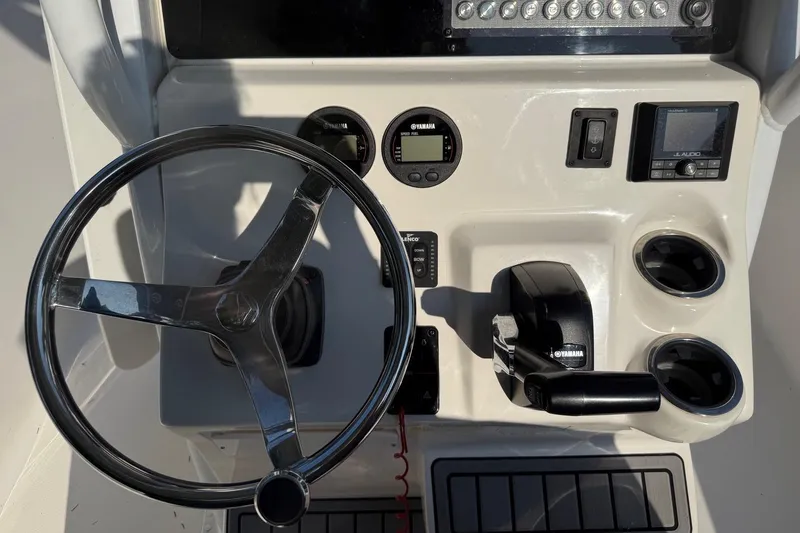 Slide: The Image of 2019 Tidewater 232 CC Adventure boat dashboard with steering wheel and Yamaha controls. - 9