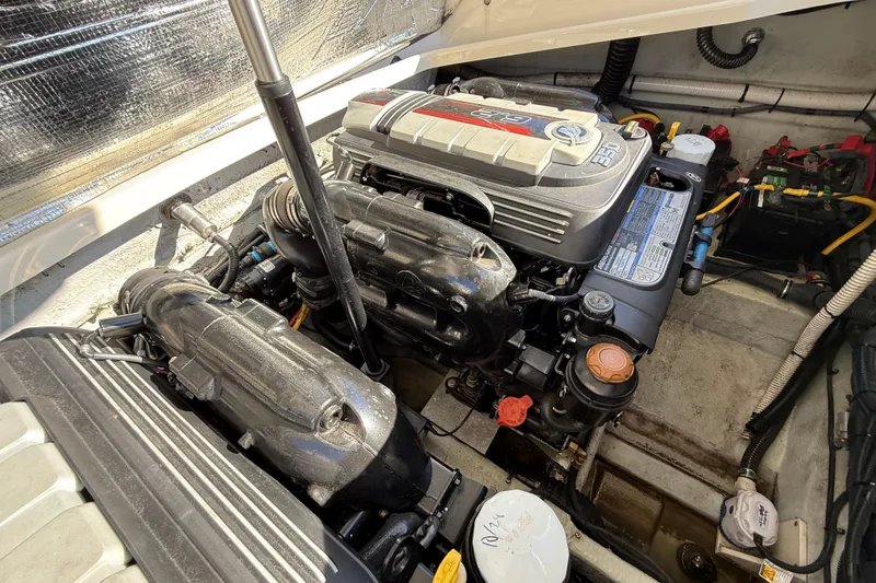 Slide: The Image of Engine compartment of a 2018 Chris-Craft Launch 30 boat, showcasing detailed mechanical components. - 13