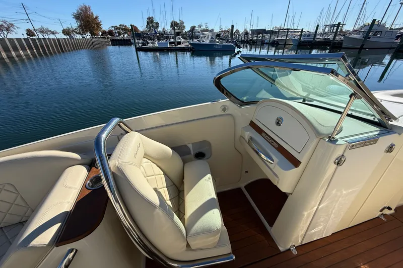 Slide: The Image of 2018 Chris-Craft Launch 30 boat interior with luxurious seating and marina view. - 25