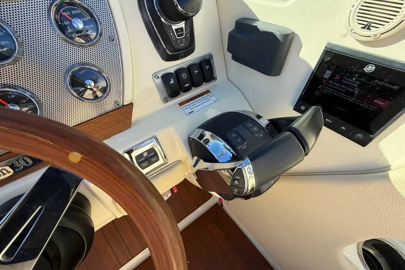 Slide: The Image of 2018 Chris-Craft Launch 30 dashboard with steering wheel and control panel. - 34
