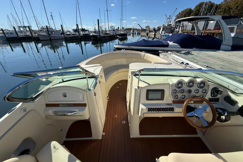 Slide: The Image of 2018 Chris-Craft Launch 30 boat interior with dashboard and steering wheel at marina. - 37