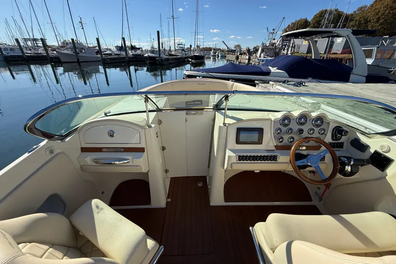 Slide: The Image of 2018 Chris-Craft Launch 30 cockpit with elegant dashboard and marina view. - 38