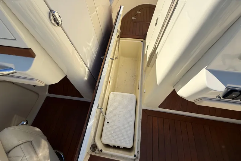 Slide: The Image of 2018 Chris-Craft Launch 30 interior storage compartment with wooden flooring. - 40