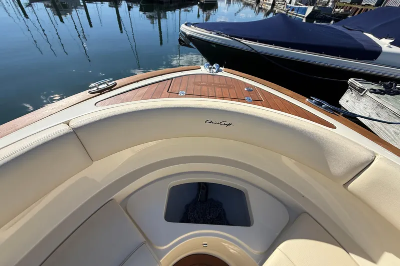 Slide: The Image of 2018 Chris-Craft Launch 30 boat with elegant wood and leather detailing at a marina. - 44