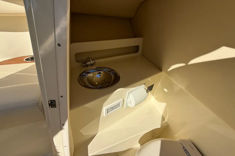 Slide: The Image of 2018 Chris-Craft Launch 30 interior with sink and toilet, showcasing luxury boat amenities. - 50