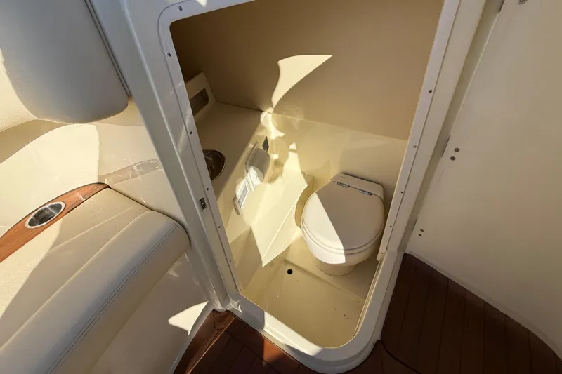 Slide: The Image of 2018 Chris-Craft Launch 30 boat interior with compact toilet and seating area. - 51
