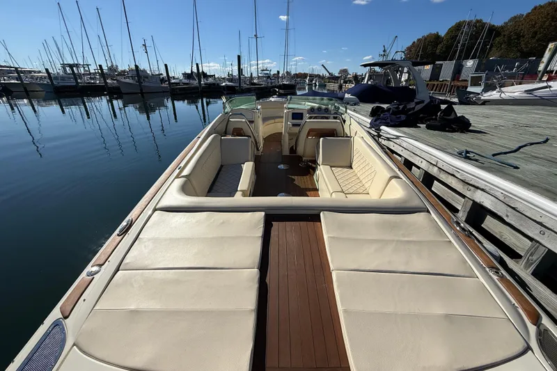 Slide: The Image of 2018 Chris-Craft Launch 30 boat docked at marina, featuring luxurious seating and sleek design. - 8