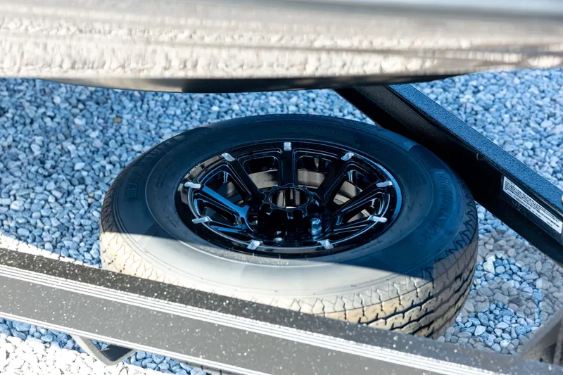 Slide: The Image of Spare tire of 2026 Skeeter ZXE20 on gravel surface. - 11