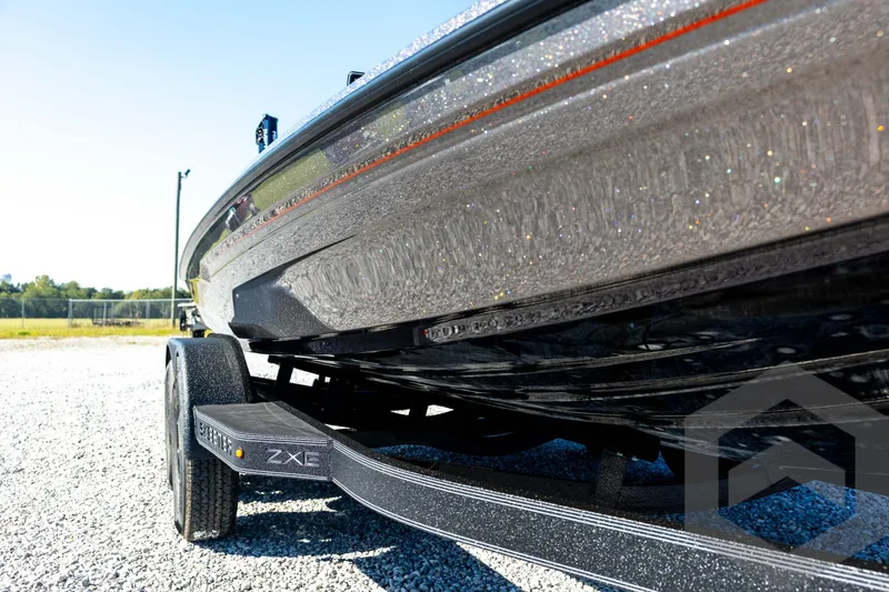 Slide: The Image of 2026 Skeeter ZXE20 boat on trailer, close-up view of hull and trailer details. - 12
