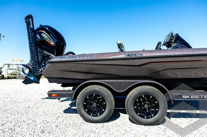 Slide: The Image of 2026 Skeeter ZXE20 boat with Yamaha engine on a trailer, parked on gravel. - 13