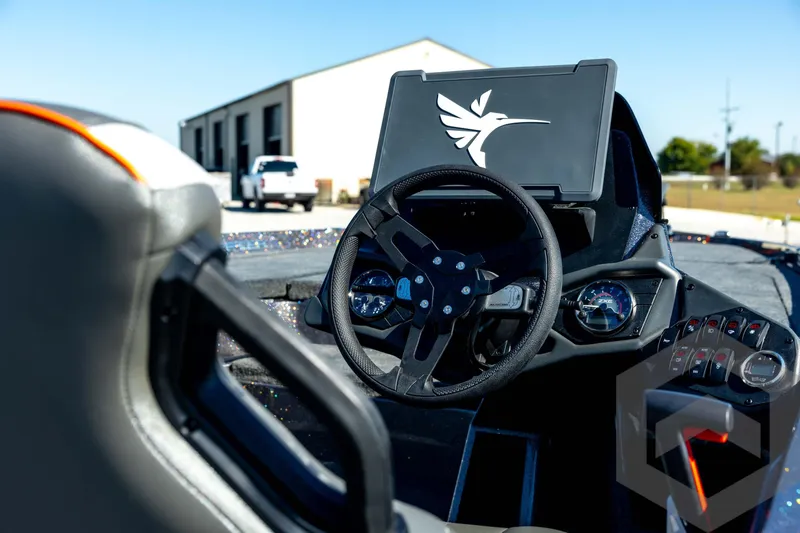 Slide: The Image of Cockpit view of 2026 Skeeter ZXE20 boat with steering wheel and dashboard controls. - 16