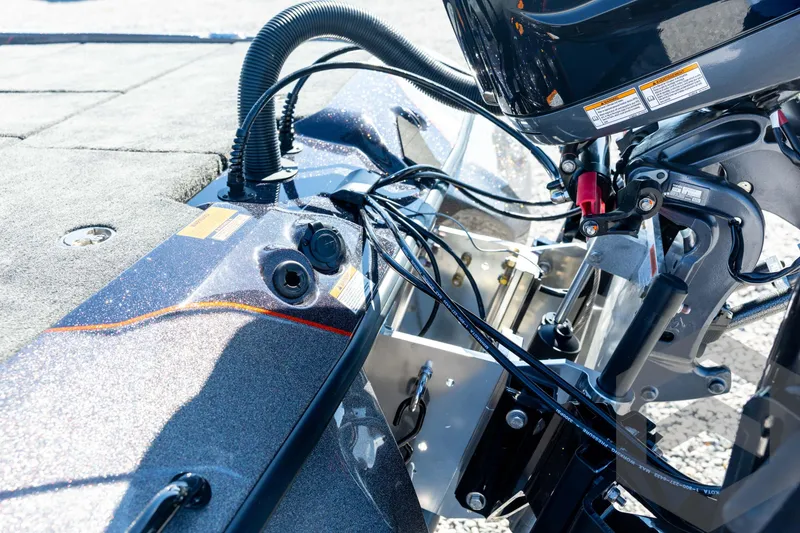 Slide: The Image of 2026 Skeeter ZXE20 boat engine and wiring details in bright sunlight. - 29