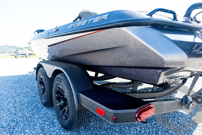 Slide: The Image of 2026 Skeeter ZXE20 boat on trailer, parked on gravel. - 30