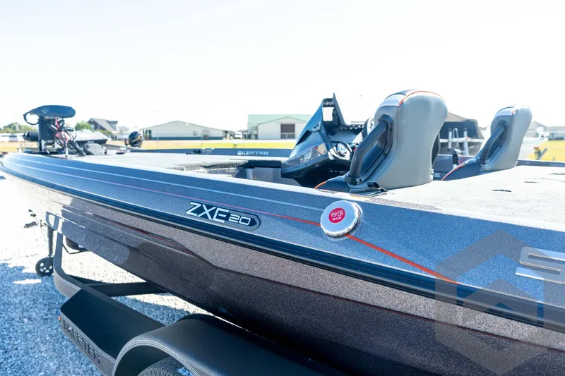 Slide: The Image of 2026 Skeeter ZXE20 boat with sleek design and modern features, parked outdoors. - 33