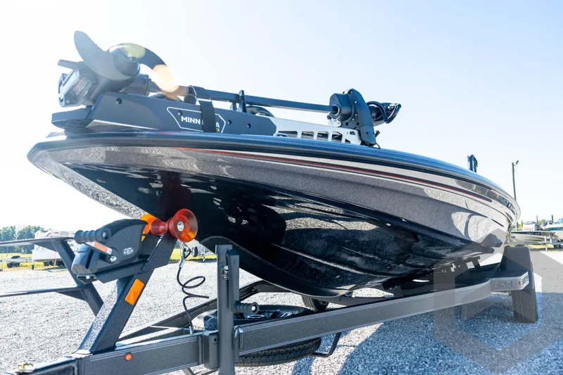Slide: The Image of 2026 Skeeter ZXE20 boat on trailer, featuring Minn Kota motor, parked on gravel. - 35
