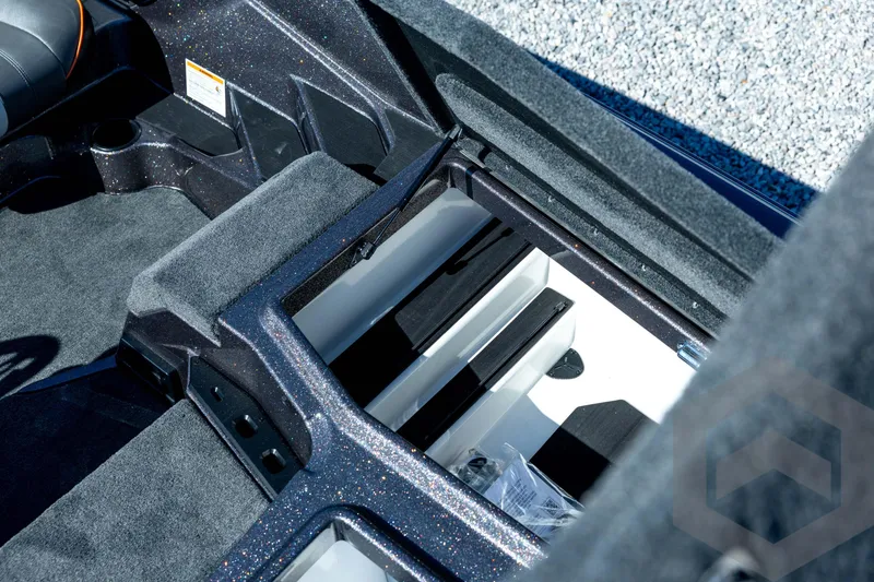 Slide: The Image of 2026 Skeeter ZXE20 boat interior storage compartment with carpeted finish and sleek design. - 55