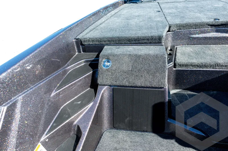 Slide: The Image of 2026 Skeeter ZXE20 boat interior with carpeted deck and storage compartments. - 56