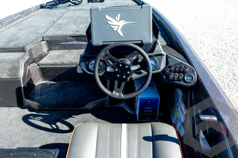 Slide: The Image of 2026 Skeeter ZXE20 boat cockpit with steering wheel and control panel. - 63