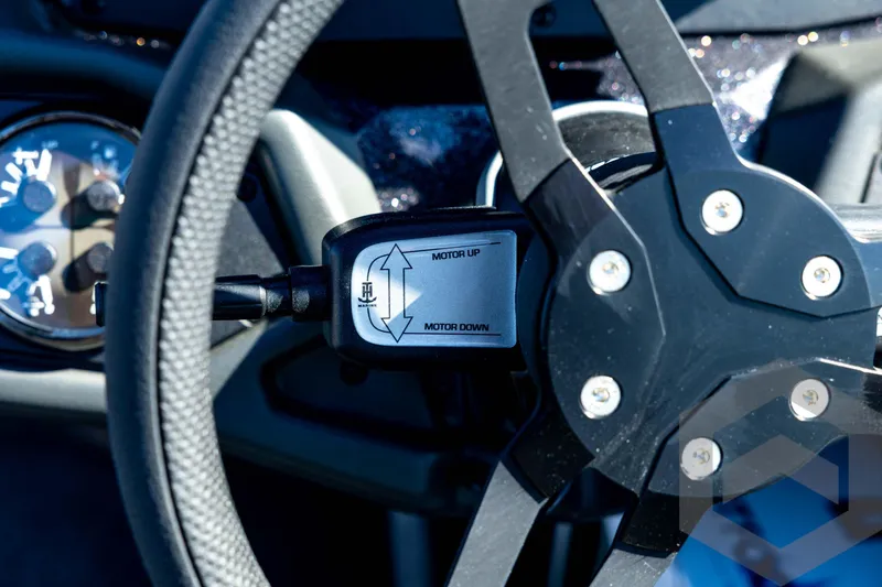 Slide: The Image of Steering wheel and controls of 2026 Skeeter ZXE20 boat, featuring motor adjustment. - 65