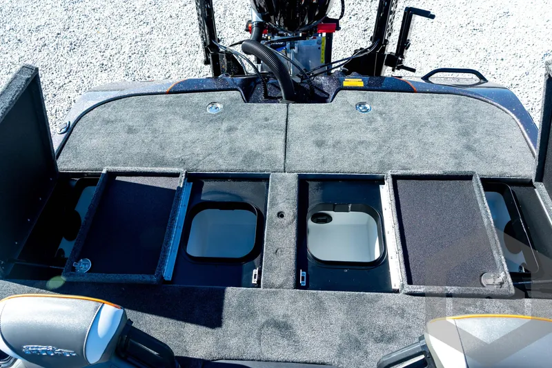 Slide: The Image of 2026 Skeeter ZXE20 boat storage compartments with open lids, showcasing interior design. - 71
