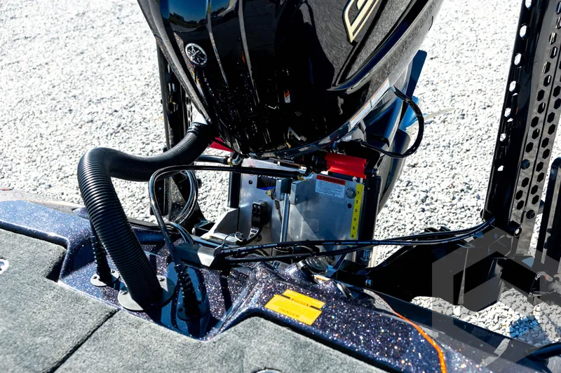 Slide: The Image of 2026 Skeeter ZXE20 boat engine and wiring details on gravel surface. - 76