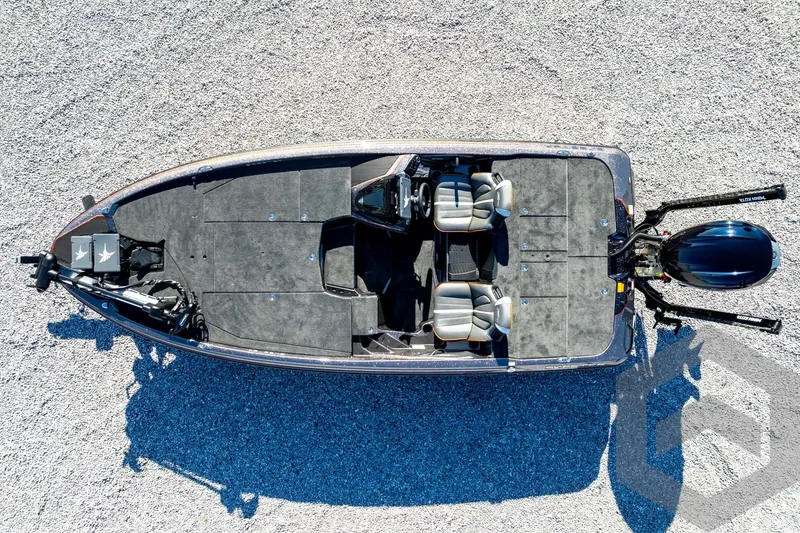 Slide: The Image of Top view of 2026 Skeeter ZXE20 boat on gravel surface, showcasing seating and motor. - 81