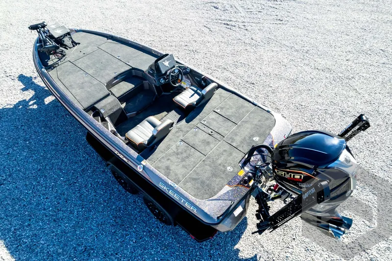 Slide: The Image of 2026 Skeeter ZXE20 fishing boat with advanced motor on gravel surface. - 83