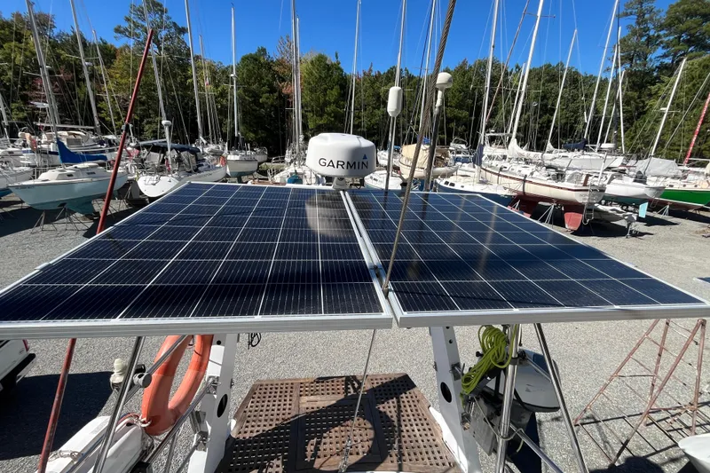Slide: The Image of Solar panels on a 1993 Med Marine Montevideo 43 sailboat, surrounded by other boats. - 10