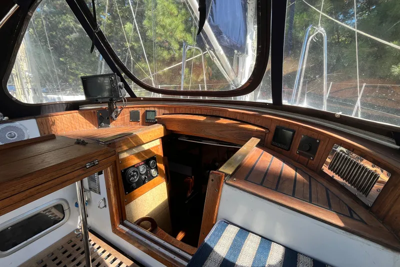 Slide: The Image of Cockpit of 1993 Med Marine Montevideo 43 sailboat with wooden interior and navigation equipment. - 13