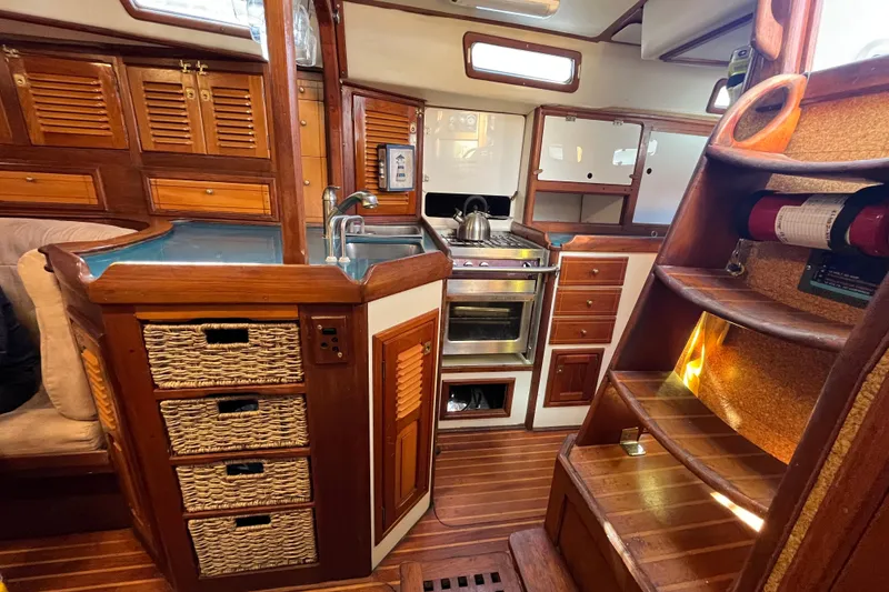 Slide: The Image of Interior of 1993 Med Marine Montevideo 43 yacht with wooden cabinetry and compact kitchen. - 14