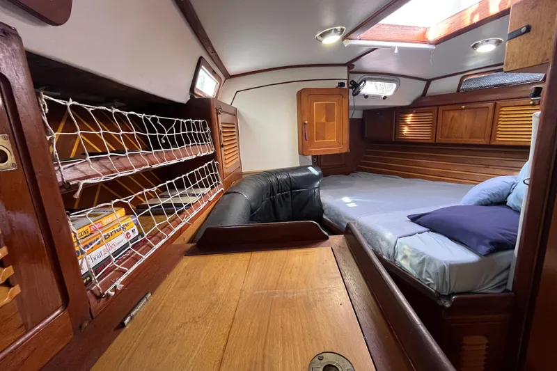 Slide: The Image of Cozy cabin interior of 1993 Med Marine Montevideo 43 with wooden furnishings and a comfortable bed. - 16
