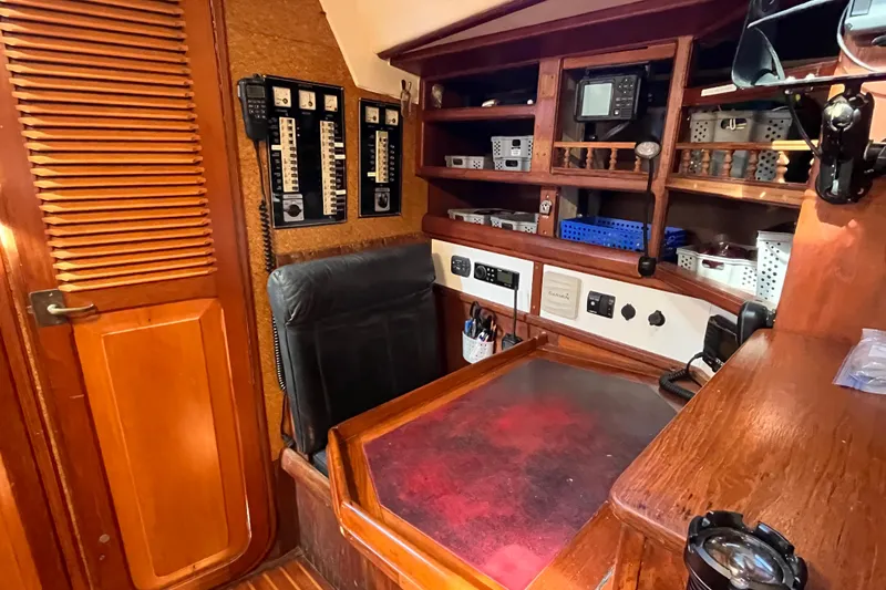 Slide: The Image of Navigation station of 1993 Med Marine Montevideo 43 yacht with control panels and storage shelves. - 18