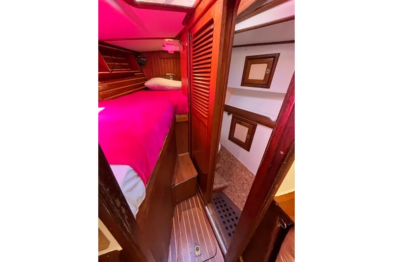 Slide: The Image of Cozy cabin interior of 1993 Med Marine Montevideo 43 with wooden accents and pink bedding. - 20